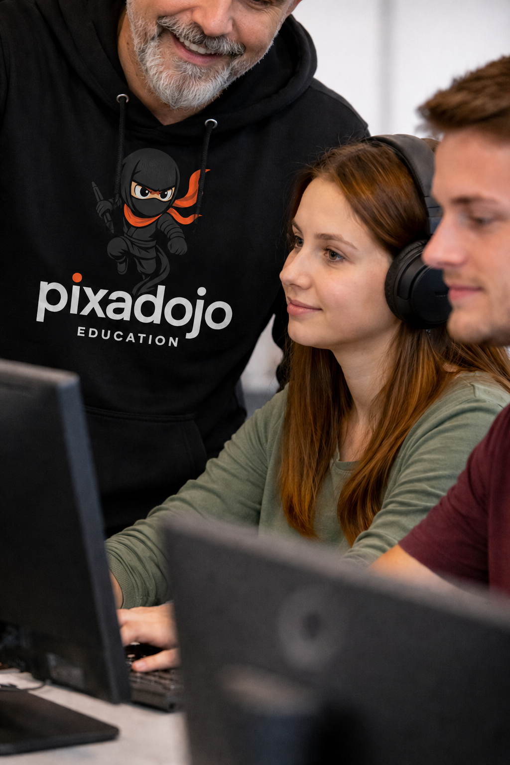 Teacher helping students at the computer